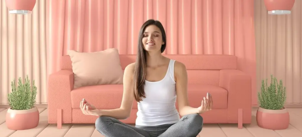 woman meditating in pink meditation room