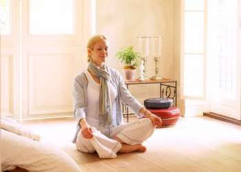 how to create a meditation room woman meditating in meditation space